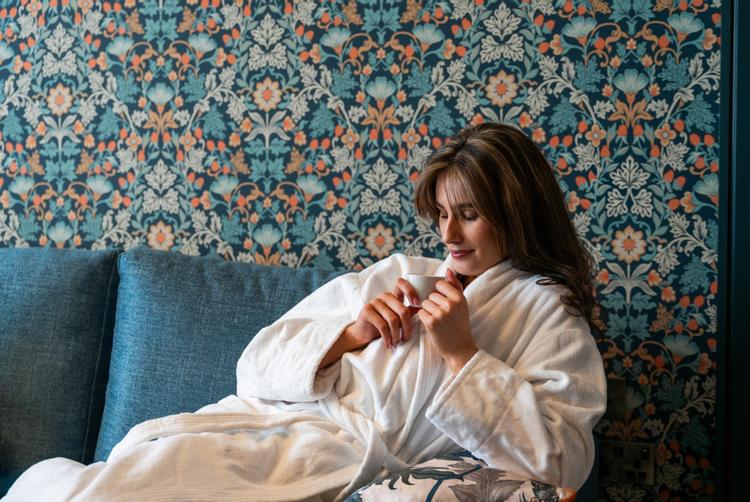 woman sitting on a chair in a robe